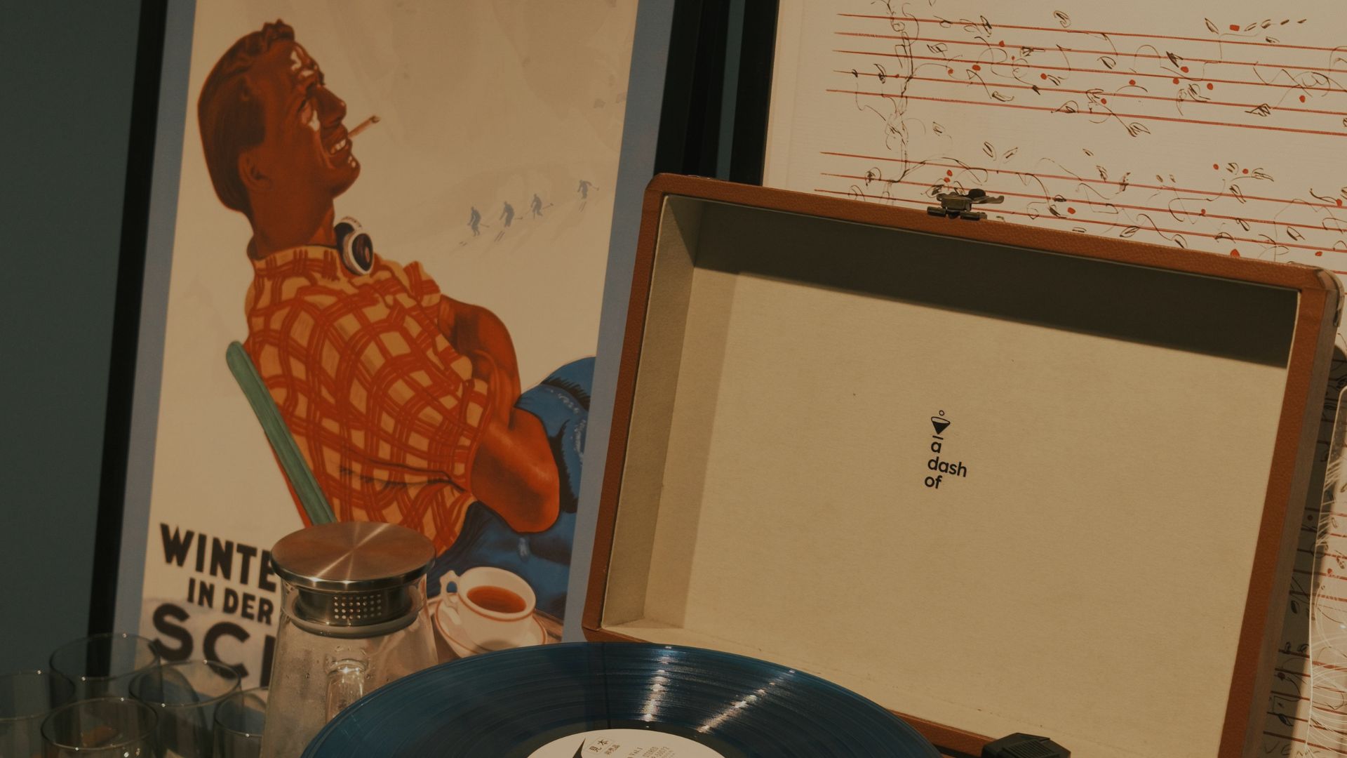 A vinyl record next to its album cover, which features vibrant artwork, linking music and visual design.