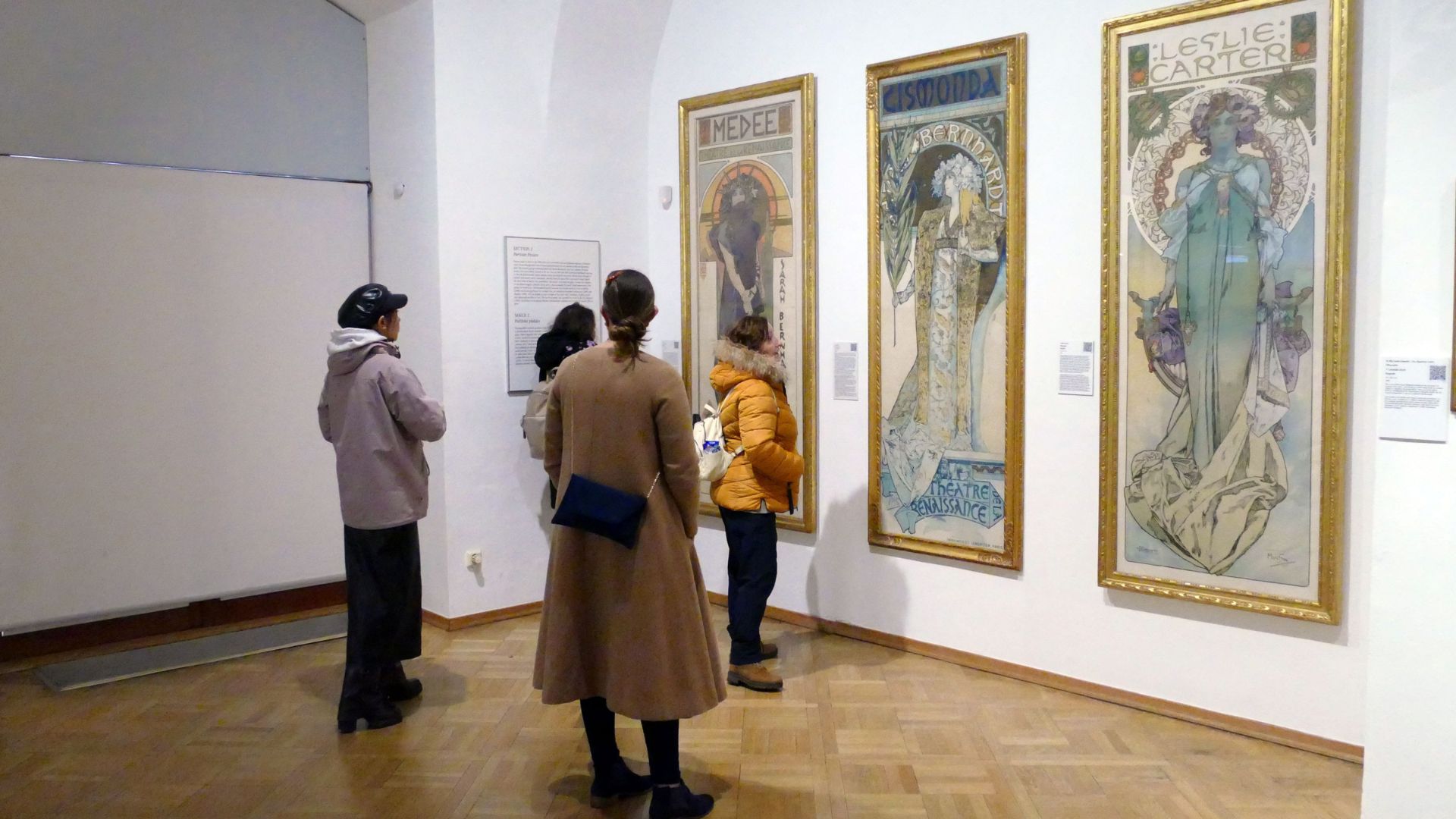 People viewing artwork in gallery, representing audience engagement and sustainable art careers.
