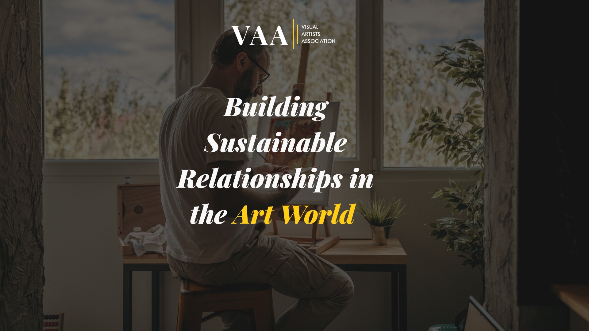 Man sitting and painting in a studio, representing sustainable art careers and creative practice.